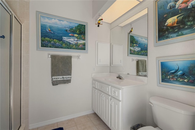 bathroom featuring toilet, vanity, an enclosed shower, and tile patterned floors