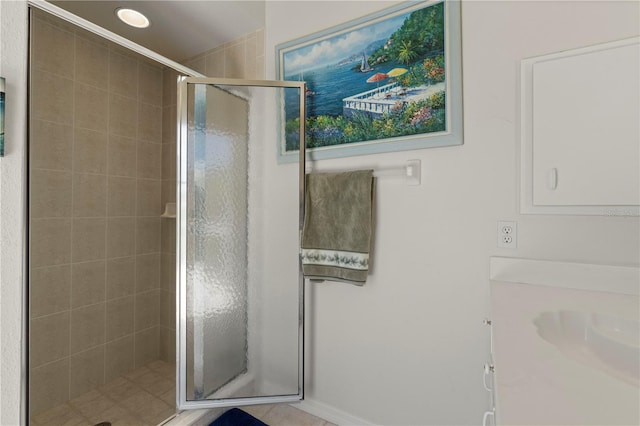 bathroom with a shower with door