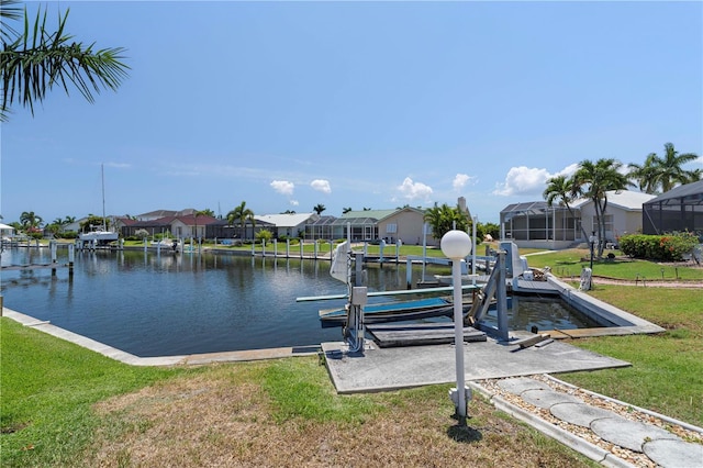 dock area featuring a lanai, a water view, and a yard