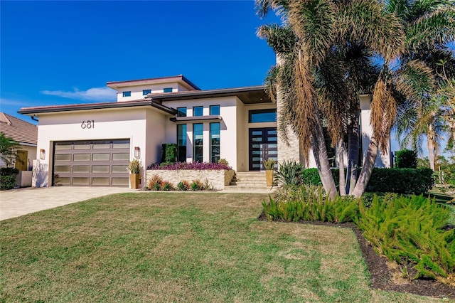 view of front facade with a front yard and a garage