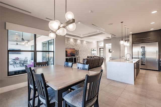 dining area featuring ceiling fan and sink