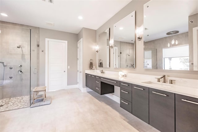 bathroom with vanity and a shower with door