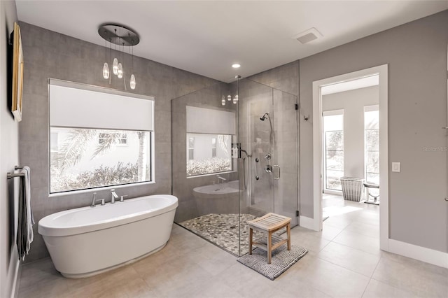 bathroom with tile patterned flooring, plus walk in shower, and a chandelier