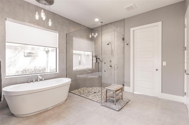 bathroom with tile patterned floors and independent shower and bath