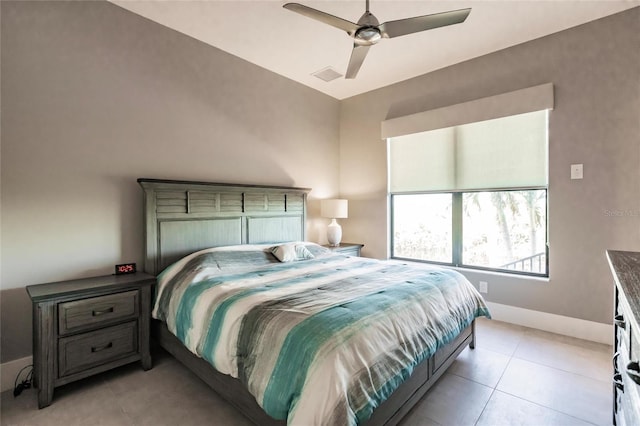 tiled bedroom featuring ceiling fan