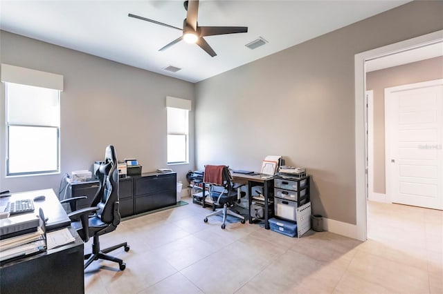 office space with ceiling fan and light tile patterned floors