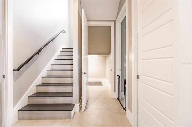 stairway with tile patterned flooring