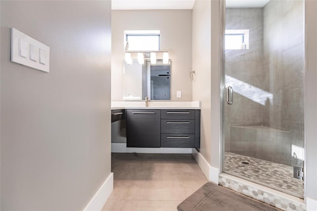 bathroom featuring tile patterned floors, vanity, and walk in shower