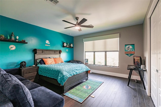 bedroom with a closet, ceiling fan, and dark hardwood / wood-style flooring