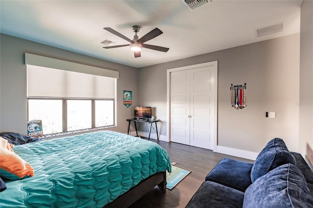 bedroom with a closet, ceiling fan, and dark hardwood / wood-style flooring