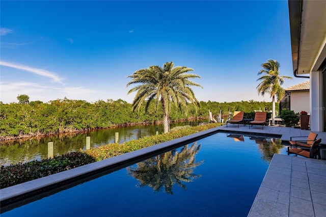 view of swimming pool featuring a water view