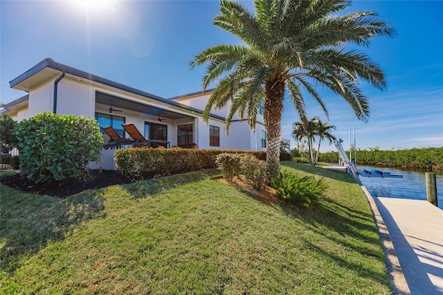 view of side of home featuring a yard