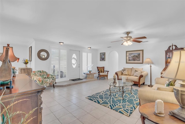 tiled living room with ceiling fan and ornamental molding