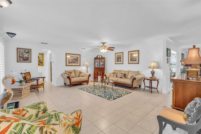 living room featuring ceiling fan, crown molding, and light tile patterned flooring