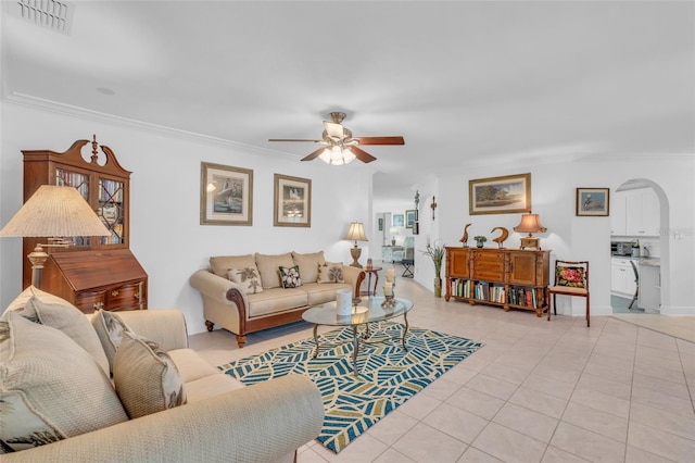 living room featuring ceiling fan, light tile patterned floors, and ornamental molding