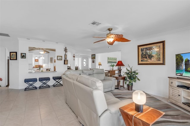 tiled living room featuring crown molding and ceiling fan