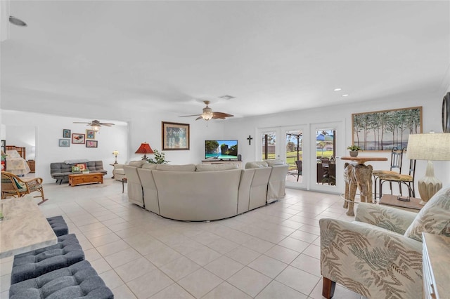 tiled living room with ceiling fan and french doors