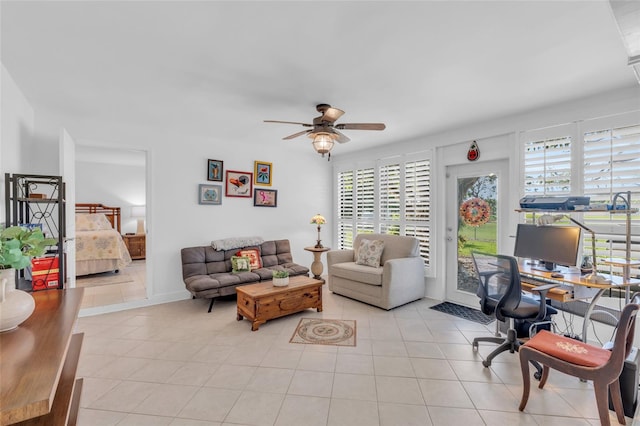 living room with ceiling fan, light tile patterned floors, and a healthy amount of sunlight