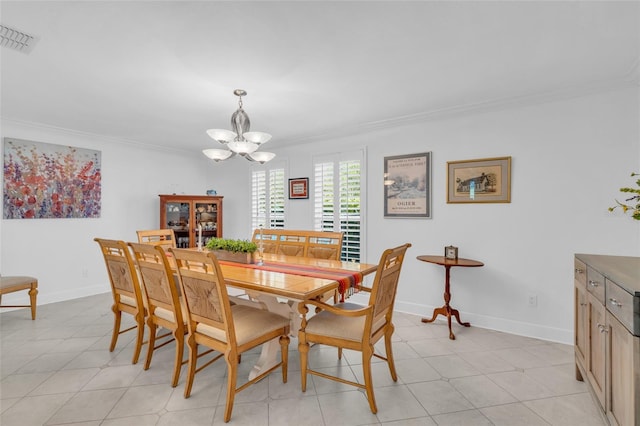 dining area with ornamental molding, light tile patterned floors, and a chandelier