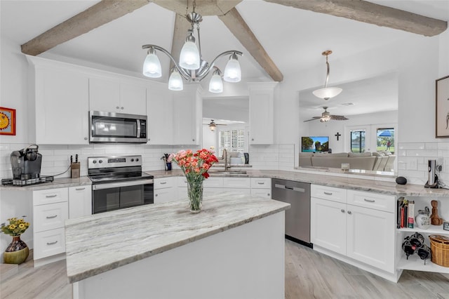 kitchen featuring appliances with stainless steel finishes, backsplash, decorative light fixtures, beamed ceiling, and white cabinets