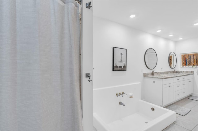 bathroom with tile patterned floors, vanity, and a washtub