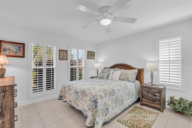 tiled bedroom with ceiling fan and multiple windows