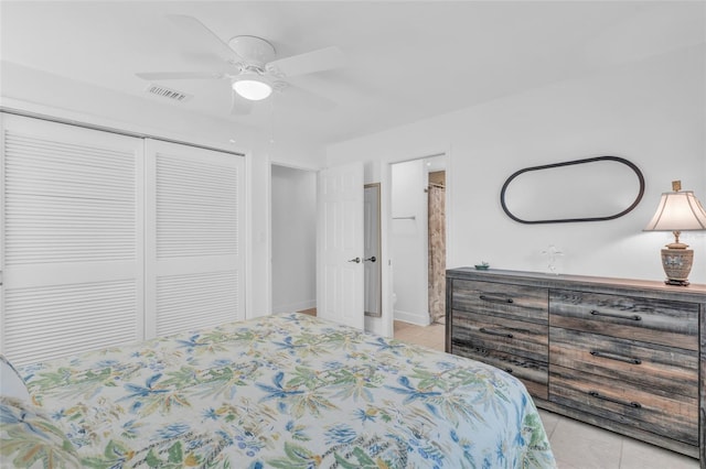 bedroom with ceiling fan, a closet, and light tile patterned floors