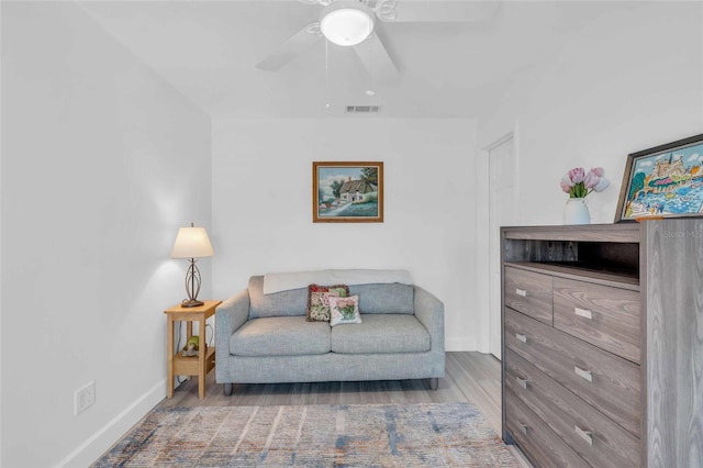 living area with light hardwood / wood-style floors and ceiling fan