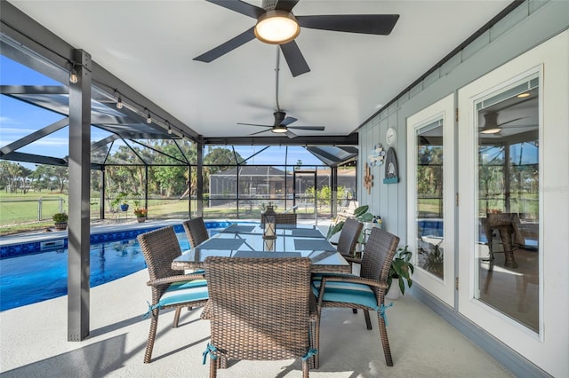 sunroom / solarium with plenty of natural light and a pool