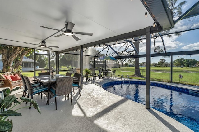 view of pool featuring a lanai, a patio area, ceiling fan, and a lawn