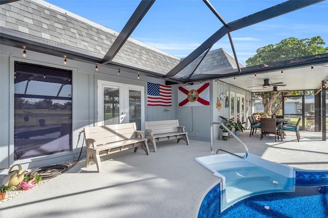 view of pool with french doors, glass enclosure, ceiling fan, and a patio area