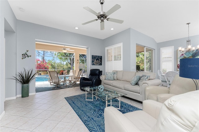 living room with light tile patterned floors and ceiling fan with notable chandelier