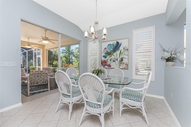 tiled dining space featuring ceiling fan with notable chandelier