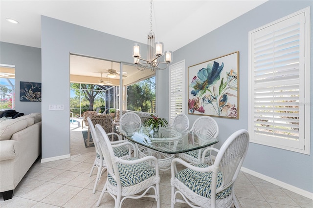 dining room featuring light tile patterned floors, ceiling fan with notable chandelier, and a wealth of natural light