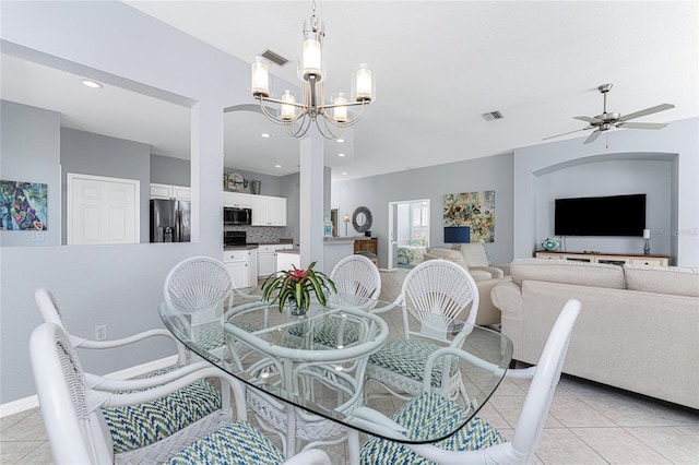 dining area featuring ceiling fan with notable chandelier and light tile patterned floors