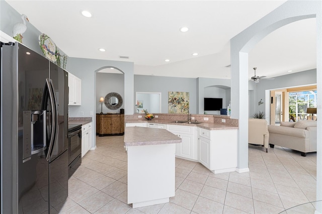 kitchen featuring a center island, black electric range, stainless steel refrigerator with ice dispenser, kitchen peninsula, and white cabinets