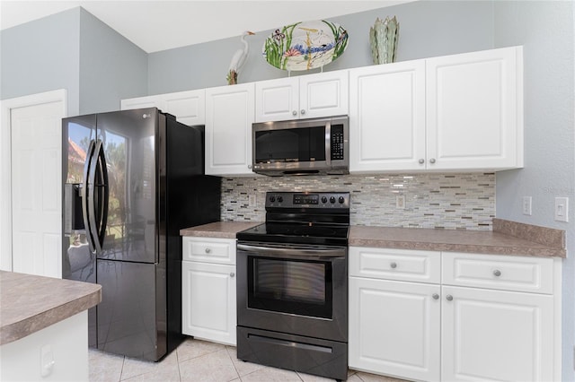 kitchen featuring backsplash, white cabinets, stainless steel appliances, and light tile patterned floors