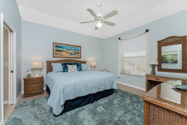 bedroom with ceiling fan and hardwood / wood-style floors