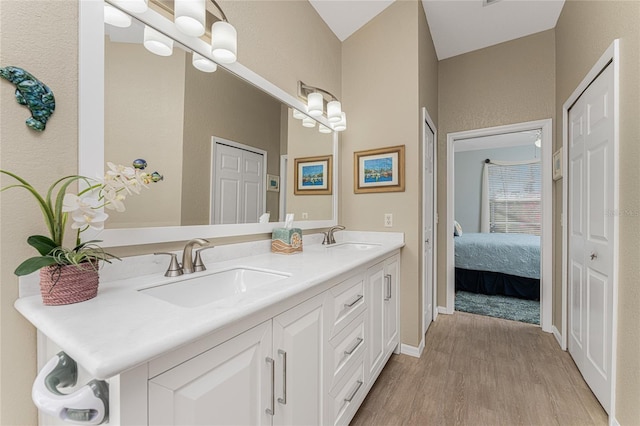 bathroom with vanity and hardwood / wood-style flooring