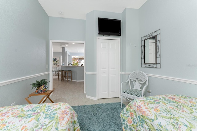 tiled bedroom featuring a closet