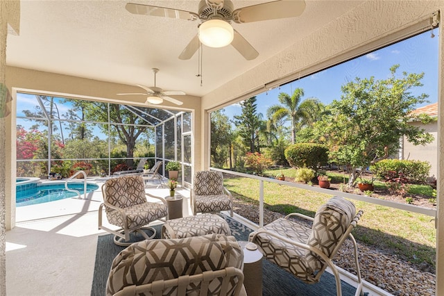 view of patio featuring outdoor lounge area, glass enclosure, and ceiling fan