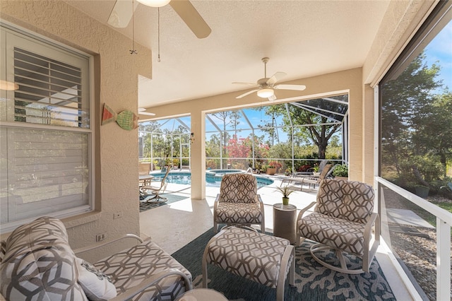 sunroom / solarium featuring ceiling fan and a swimming pool