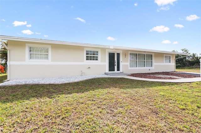 ranch-style home with a front lawn