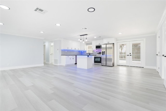 unfurnished living room featuring french doors, light hardwood / wood-style flooring, sink, and crown molding