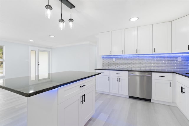 kitchen featuring white cabinets, backsplash, dishwasher, and ornamental molding