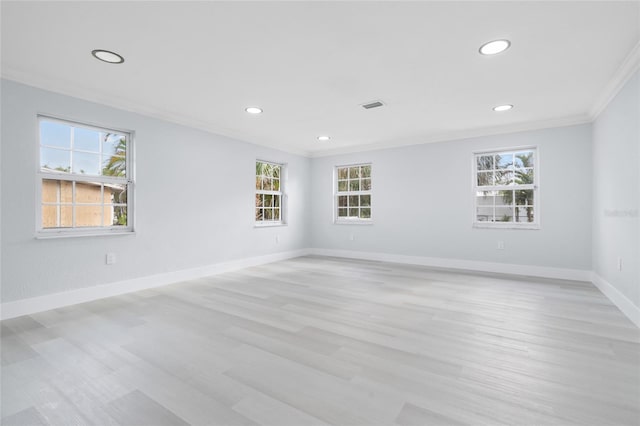 unfurnished room featuring ornamental molding and light hardwood / wood-style floors