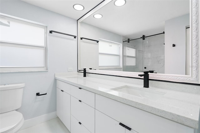 bathroom featuring toilet, vanity, tile patterned flooring, and a shower with shower door