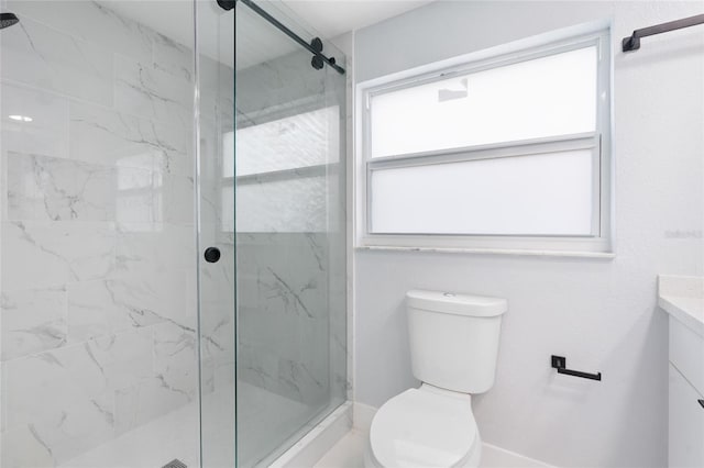 bathroom featuring vanity, toilet, and tiled shower