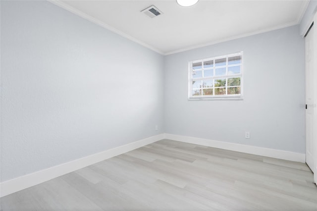 unfurnished room featuring light wood-type flooring and crown molding