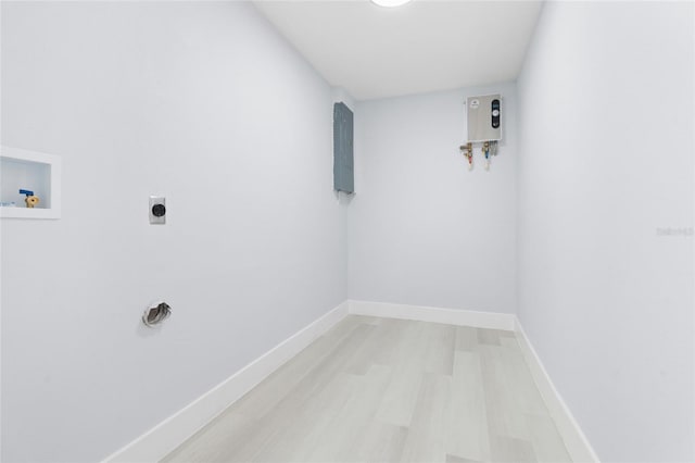 washroom featuring washer hookup, hookup for an electric dryer, light hardwood / wood-style flooring, electric panel, and water heater